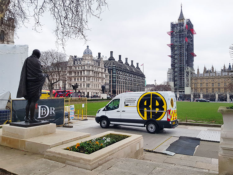 Roger Bullivant vehicle next to the statue of Mahatma Gandhi statue