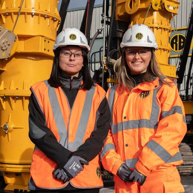 Two female Roger Bullivant employess standing next to each other wearing safety gear